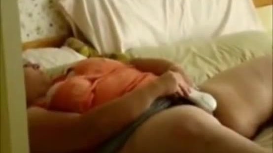 Voyeuring my 46 years old mom masturbating on bed